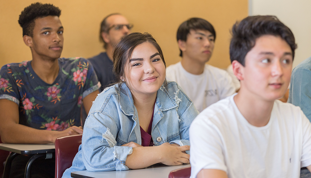 Three SBCC students sitting at desks